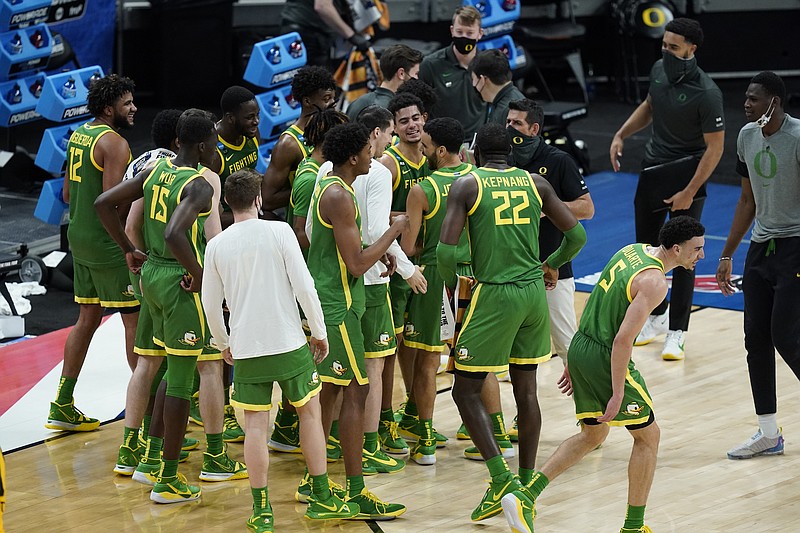 Oregon players celebrate following a second-round game against Iowa. in the NCAA men's college basketball tournament at Bankers Life Fieldhouse, Monday, March 22, 2021, in Indianapolis. Oregon won 95-80. (AP Photo/Darron Cummings)