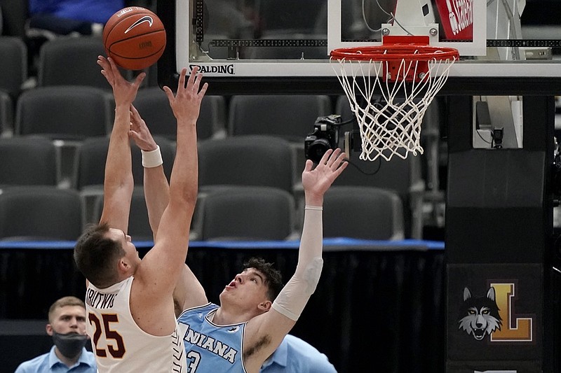 Loyola of Chicago's Cameron Krutwig (25) shoots over Indiana State's Jake LaRavia during the first half of an NCAA college basketball game in the semifinal round of the Missouri Valley Conference men's tournament Saturday, March 6, 2021, in St. Louis. (AP Photo/Jeff Roberson)