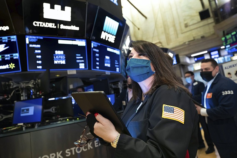 FILE - In this Wednesday March 10, 2021 photo provided by the New York Stock Exchange, trader Phyllis Arena Woods works on the trading floor. A year earlier, a terrifying free fall for the stock market suddenly ended, ushering in one of its greatest runs. (Nicole Pereira/New York Stock Exchange via AP)