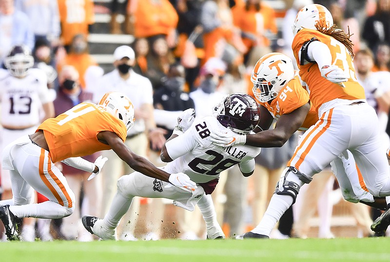 Southeastern Conference photo / Returning Tennessee defenders Warren Burrell (4), Matthew Butler (94) and Jeremy Banks (33) close in on Texas A&M running back Isaiah Spiller during last December's 34-13 win by the Aggies inside Neyland Stadium. The Volunteers start spring practice Thursday.