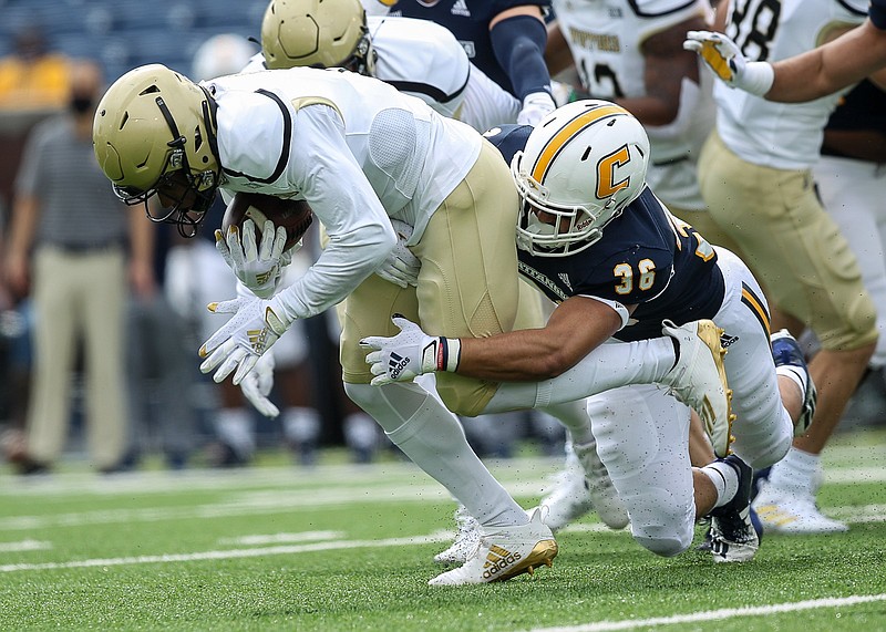 Staff photo by Troy Stolt / Chattanooga Mocs linebacker Christian Snyder (36) makes a tackle in the Wofford back field during the football game between UTC and the Wofford Terriers at Finley Stadium on Saturday, Feb. 27, 2021 in Chattanooga, Tenn.