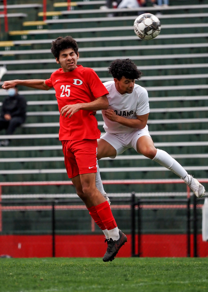 Staff photo by C.B. Schmelter / Dalton's Fabian Rodriguez (25) and Carrollton's Nathan Upson (3) contest for the ball on Harmon Field at Bill Chappell Stadium on Tuesday, March 23, 2021 in Dalton, Ga.