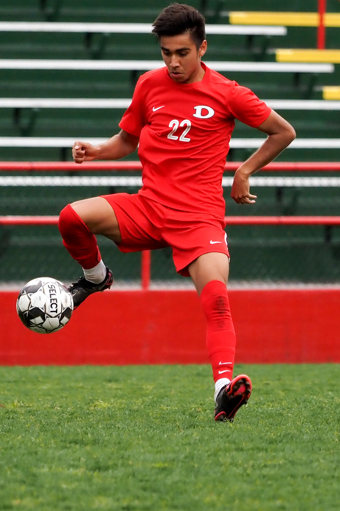 Staff photo by C.B. Schmelter / Dalton's Alejandro Martinez (22) passes the ball against Carrollton on Harmon Field at Bill Chappell Stadium on Tuesday, March 23, 2021 in Dalton, Ga.
