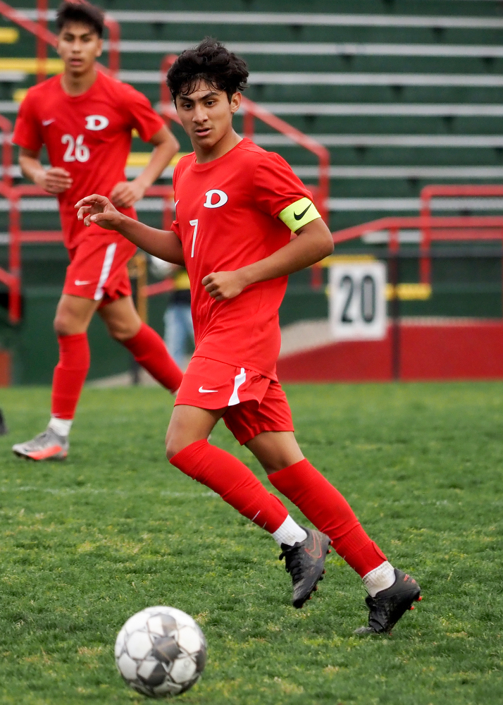 Staff photo by C.B. Schmelter / Dalton's Damian Rodriguez (7) watches his pass against Carrollton on Harmon Field at Bill Chappell Stadium on Tuesday, March 23, 2021 in Dalton, Ga.