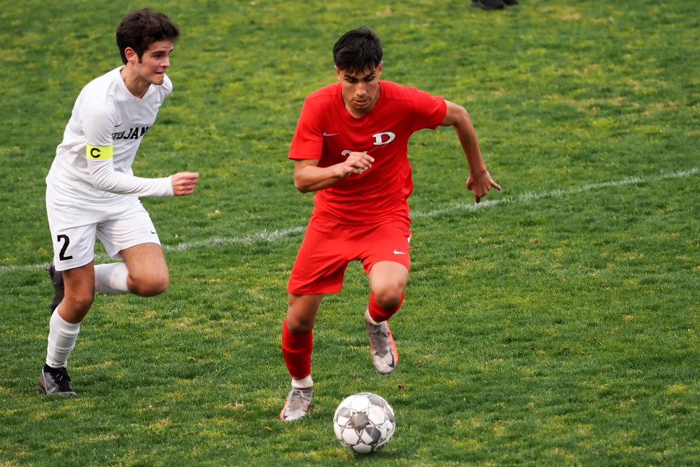 Staff photo by C.B. Schmelter / Carrollton's Cole Fendley (2) chases Dalton's Yahir Paez (26) on Harmon Field at Bill Chappell Stadium on Tuesday, March 23, 2021 in Dalton, Ga.