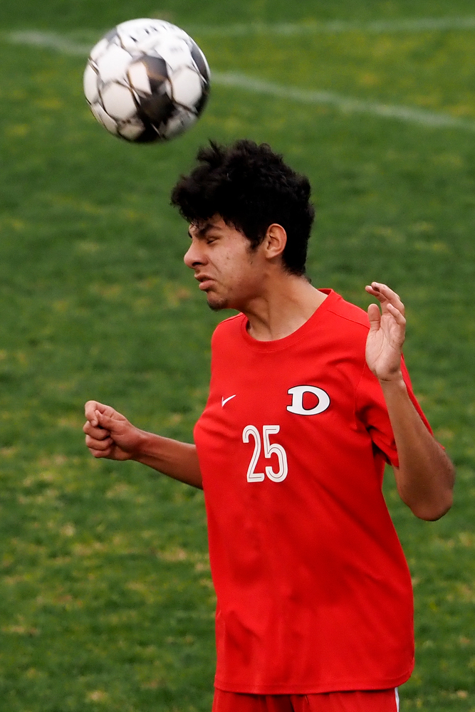 Staff photo by C.B. Schmelter / Dalton's Fabian Rodriguez (25) heads the ball against Carrollton on Harmon Field at Bill Chappell Stadium on Tuesday, March 23, 2021 in Dalton, Ga.