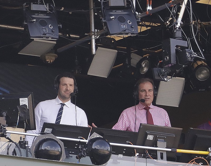 FILE - In this Sept. 24, 2017, file photo, Tony Romo and Jim Nantz work in the broadcast booth before an NFL football game between the Green Bay Packers and the Cincinnati Bengals in Green Bay, Wis. 