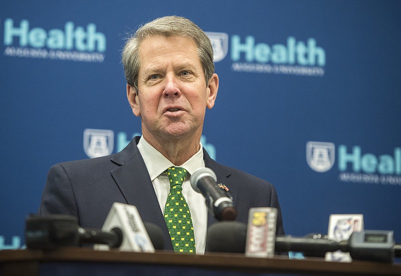 Georgia Gov. Brian Kemp answers questions from reporters during a news conference following a COVID-19 Vaccine Roundtable meeting Wednesday morning March 17, 2020 at Augusta University in Augusta, Ga. (Michael Holahan/The Augusta Chronicle via AP)