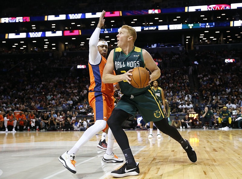 FILE - 3's Company player captain and coach Allen Iverson, left, defends Ball Hogs Brian Scalabrine during the first half of Game 3 in the BIG3 Basketball League debut, Sunday, June 25, 2017, at the Barclays Center in New York. (AP Photo/Kathy Willens)