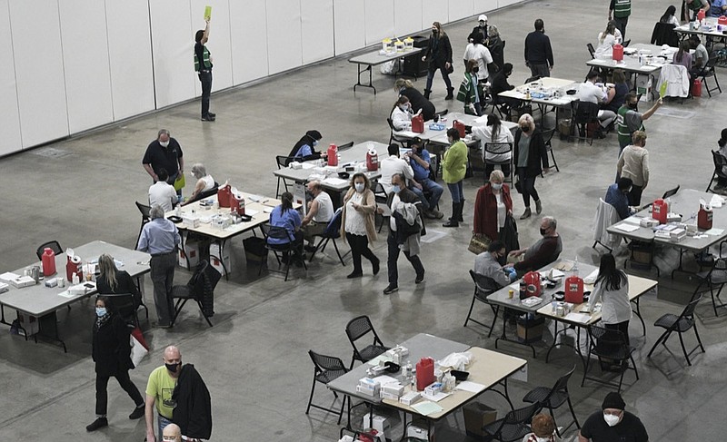 FILE - In this March 17, 2021, file photo, people show up to the Schaumburg Convention Center for the Pfizer COVID1-19 vaccination in Schaumburg, Ill. (Mark Welsh /Daily Herald via AP, File)


