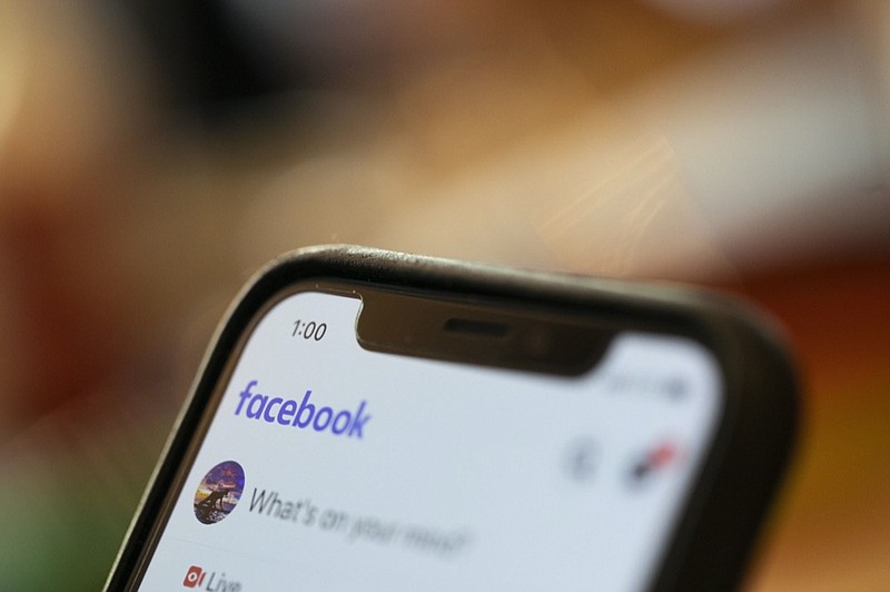 FILE - In this Aug. 11, 2019, file photo an iPhone displays a Facebook page in New Orleans. (AP Photo/Jenny Kane, File)


