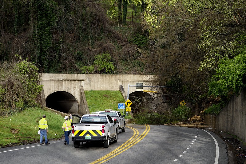 Staff file photo by C.B. Schmelter / Two workers look at the damage caused by a landslide on the east side of the Bachman Tunnels on Thursday, March 18, 2021, in East Ridge, Tenn. The Tennessee Department of Transportation said permanent repairs will start Friday at 9 a.m. and be completed by April 16.