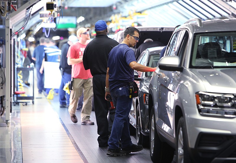 Staff file photo / Volkswagen employees perform tests on vehicles as they reach the end of the assembly line at the plant that will build the ID.4 all-electric SUV in 2022.