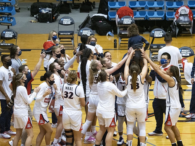 AP photo by Michael Thomas / Arizona women's basketball coach Adia Barnes' son Matteo is held up by the Wildcats after they beat BYU in an NCAA tournament second-round game Wednesday to reach the Sweet 16 for the first time since 1998, when Barnes was a player for the team.