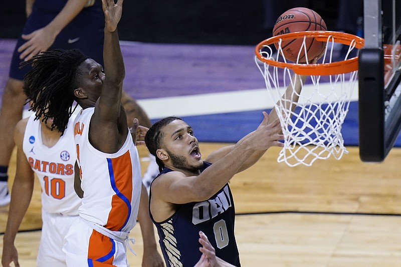 AP photo by AJ Mast / Oral Roberts forward Kevin Obanor drives to the basket ahead of Florida's Anthony Duruji during an NCAA tournament second-round game Sunday in Indianapolis. Obanor has helped the Golden Eagles advance to the Sweet 16 despite being seeded 15th in the South Region.