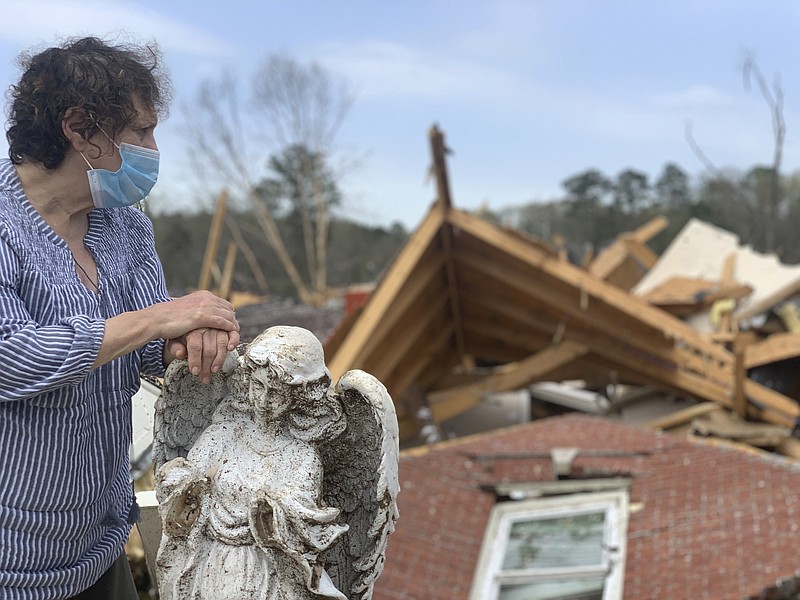 Associated Press Photo by Kim Chandler / Mary Rose DeArman, 69, describes how she and her husband sheltered in a basement closet when a tornado struck their neighborhood in Shelby County, Alabama. The twister, which struck on Thursday, collapsed their brick home on top of them, but they escaped without serious injury.