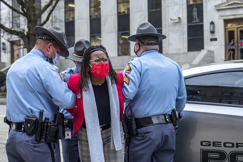 State Rep. Park Cannon, D-Atlanta, is placed into the back of a Georgia State Capitol patrol car after being arrested by Georgia State Troopers at the Georgia State Capitol Building in Atlanta, Thursday, March 25, 2021. (Alyssa Pointer/Atlanta Journal-Constitution via AP)


