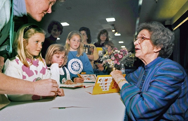 FILE - In this April 19, 1998 file photo, Beverly Cleary signs books at the Monterey Bay Book Festival in Monterey, Calif. (Vern Fisher/The Monterey County Herald via AP, File)


