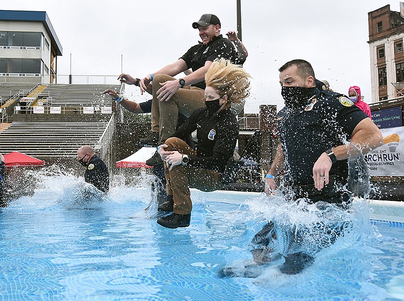 Staff photo by Matt Hamilton / Chattanooga Police Department investigator Hunter Morgan, Lt. Heather Williams and Chief David Roddy jump into the pool.