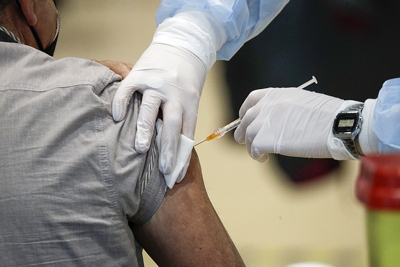 FILE - In this Friday, March 19, 2021 file photo medical staff members administer the AstraZeneca vaccine at La Nuvola (The Cloud) convention center that was temporarily turned into a COVID-19 vaccination hub, in Rome. AstraZeneca said Monday March 22, 2021 that advanced trial data from a U.S. study on its COVID vaccine shows it is 79% effective. The U.S. study comprised 30,000 volunteers, 20,000 of whom were given the vaccine while the rest got dummy shots. (AP Photo/Gregorio Borgia)