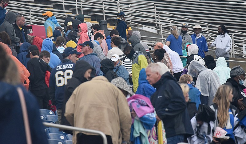 Staff photo by Matt Hamilton / Fans head for cover during a lightning delay at UTC's football game against Mercer on Saturday at Finley Stadium.