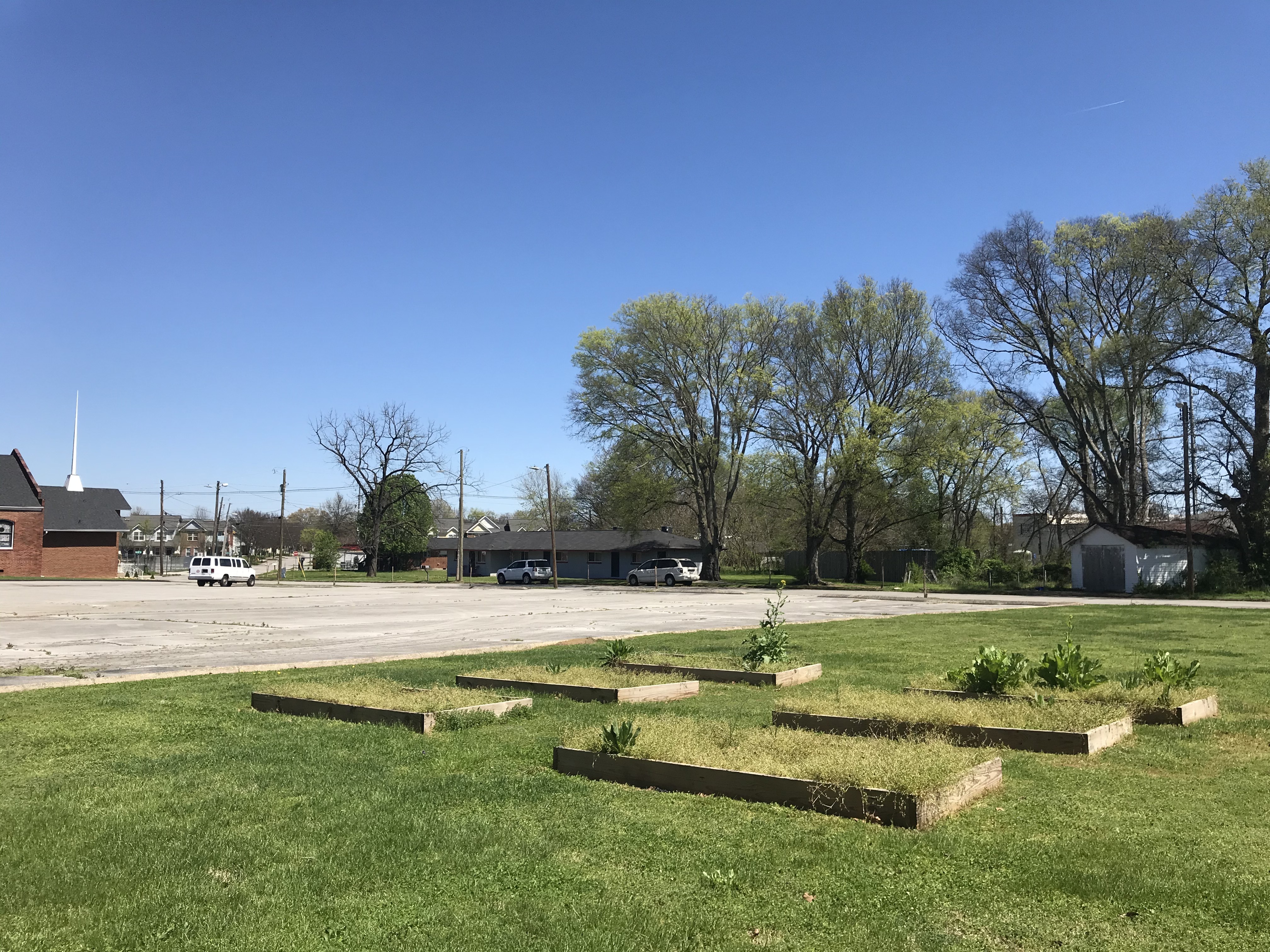 Staff photo by Emily Crisman / Empty lots, a parking lot and an inactive community garden on Hughes Avenue in Alton Park are being revitalized through the Net Resource Foundation's Hughes Project.
