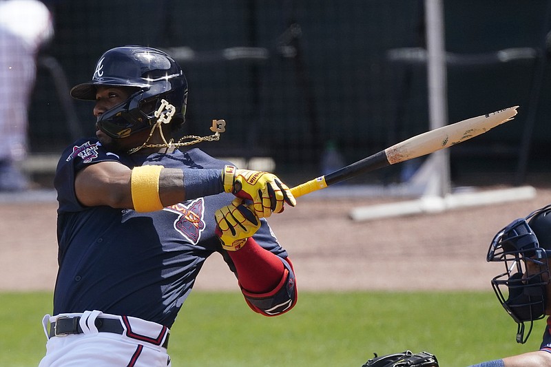 Atlanta Braves' Ronald Acuna Jr. (13) breaks his bat as he pops out in the third inning of a spring training baseball game against the Minnesota Twins, Friday, March 5, 2021, in North Port, Fla. (AP Photo/John Bazemore)