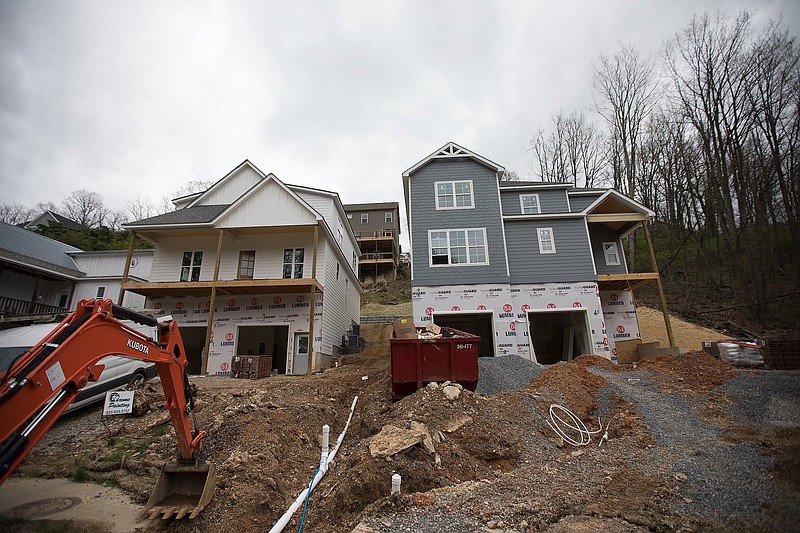 Staff photo by Troy Stolt / Homes are undergoing construction on Tremont Street. The City Council passed a new measure on first reading aimed at putting more regulations building on steep slopes