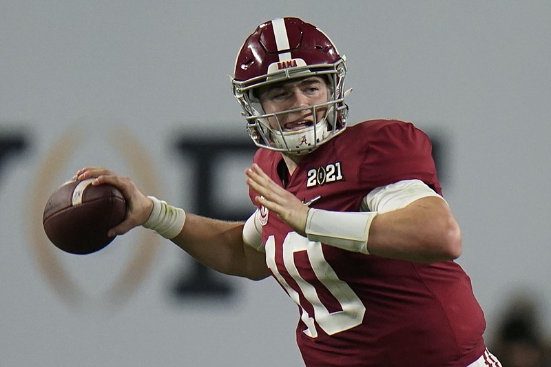 FILE - Alabama quarterback Mac Jones passes against Ohio State during the second half of an NCAA College Football Playoff national championship game in New Orleans, in this Monday, Jan. 11, 2021, file photo. Ohio State quarterback Justin Fields was among 98 juniors granted eligibility by the NFL into the draft, while national championship-winning QBs Mac Jones from Alabama and Trevor Lawrence from Clemson were among another 30 players eligible after completing their degrees and deciding not to play more in college. (AP Photo/Chris O'Meara, File)