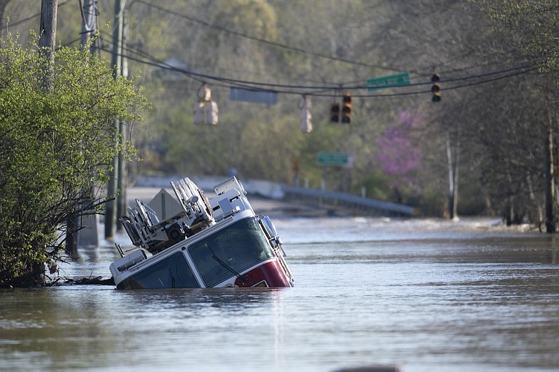 A Nashville Fire Department truck is revealed as flood waters from the Harpeth River recede Monday, March 29, 2021, in Nashville, Tenn. Recent storms dropped seven inches of rain in the area that resulted in flooding and flash flooding across the city. (George Walker IV, The Tennessean via AP)