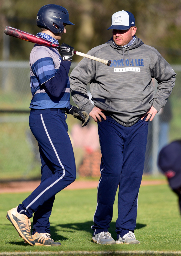 Staff Photo by Robin Rudd / Gordon Lee's Jake Poindexter (27) confers with head coach Mike Dunfee. The Gordon Lee Trojans faced the South Pittsburg Pirates in the Lookout Valley Classic, at Lookout Valley High School, on April 1, 2021.