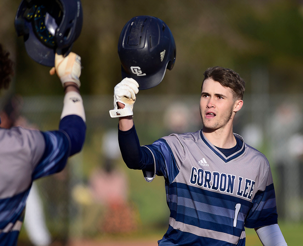 Staff Photo by Robin Rudd / Gordon Lee's Griffin Collins (1) taps helmets with a teammate, as he prepares to touch home plate after hitting a home run against the South Pittsburg Pirates in the Lookout Valley Classic, at Lookout Valley High School, on April 1, 2021.