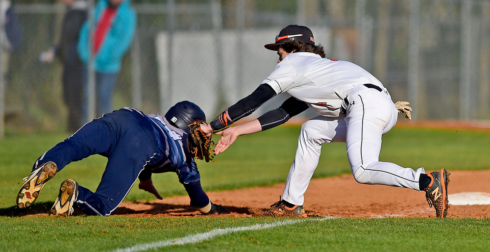 Staff Photo by Robin Rudd / South Pittsburg third baseman Hunter Powers (4) tags out Gordon Lee's Kade Cowan (24). The Gordon Lee Trojans faced the South Pittsburg Pirates in the Lookout Valley Classic, at Lookout Valley High School, on April 1, 2021.