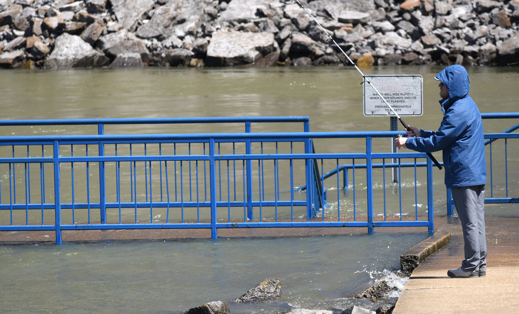 Staff Photo by Matt Hamilton / Flintstone, Ga. resident Russ Young fishes beside the partially-covered pier at the Chickamauga Dam on Thursday, April 1, 2021.