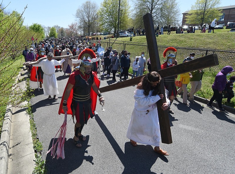 Staff Photo by Matt Hamilton / Jesus, played by Avelino Villalobos, carries his cross as hundreds follow as part of the Good Friday celebration at St. Joseph's Catholic Church in Dalton, Ga. on Friday, April 2, 2021.
