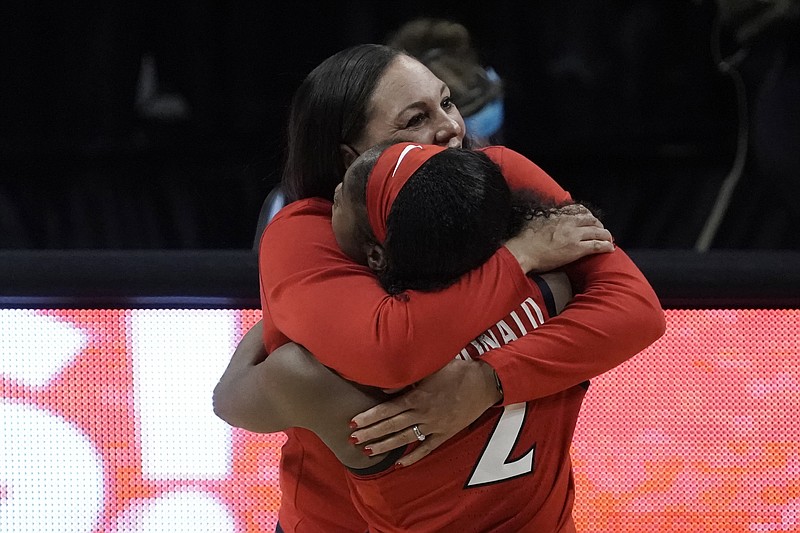 AP photo by Morry Gash / Arizona women's basketball coach Adia Barnes gets a hug from guard Aari McDonald after the Wildcats beat Connecticut 69-59 in the Final Four on Friday night at the Alamodome in San Antonio.