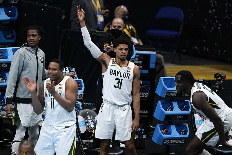 AP photo by Michael Conroy / Baylor's Mark Vital (11), MaCio Teague (31) and Jonathan Tchamwa Tchatchoua, right, celebrate on the bench during the first half of their Final Four game against Houston on Saturday at Lucas Oil Stadium in Indianapolis.
