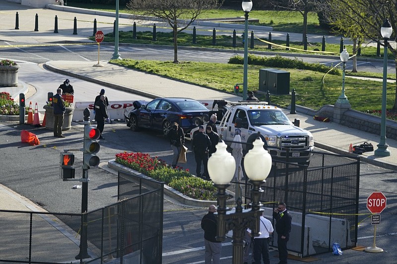 Authorities investigate the scene after a man rammed a car into two officers at the barricade on Capitol Hill in Washington, Friday, April 2, 2021. (AP Photo/Alex Brandon)


