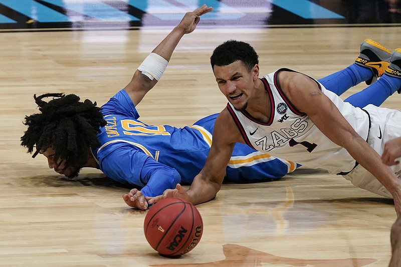 AP photo by Michael Conroy / Gonzaga guard Jalen Suggs, right, scrambles for a loose ball alongside UCLA's Tyger Campbell during a Final Four matchup Saturday night at Lucas Oil Stadium in Indianapolis.