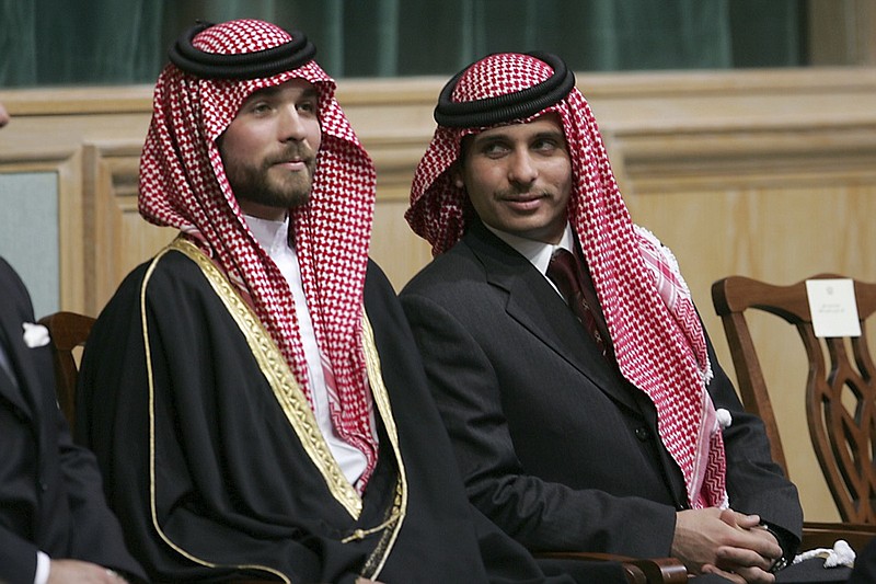 File - In this Tuesday, Nov. 28, 2006 file photo, Prince Hamza Bin Al-Hussein, right, and Prince Hashem Bin Al-Hussein, left, brothers King Abdullah II of Jordan, attend the opening of the parliament in Amman, Jordan. Prince Hamza, the half-brother of Jordan's King Abdullah II, said he has been placed under house arrest. in a videotaped statement late Saturday, April 3, 2021. (AP Photo/Mohammad abu Ghosh, File)