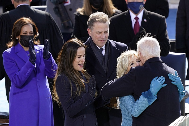 Photo by Carolyn Kaster of The Associated Press / President Joe Biden hugs first lady Jill Biden, as his son Hunter Biden and daughter Ashley Biden look on after being sworn-in during the 59th presidential inauguration at the U.S. Capitol in Washington on Wednesday, Jan. 20, 2021.