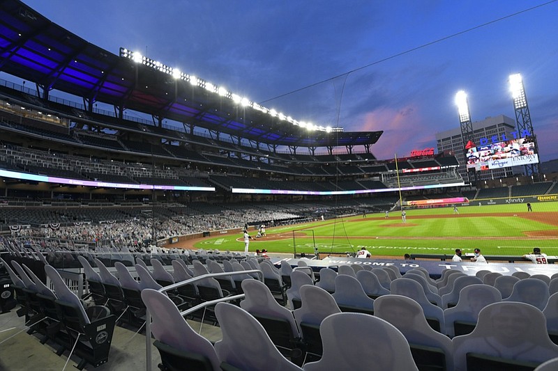 FILE - Cardboard cutouts of fans in the otherwise empty seats face the field during the sixth inning of a baseball game between the Atlanta Braves and Tampa Bay Rays in Atlanta, in this Thursday, July 30, 2020, file photo. Georgia's new voting law _ which critics claim severely limits access to the ballot box, especially for people of color _ has prompted calls from as high as the White House to consider moving the midsummer classic out of Atlanta. The game is set for July 13 at Truist Park, the Braves' 41,000-seat stadium in suburban Cobb County.(AP Photo/John Amis, File)