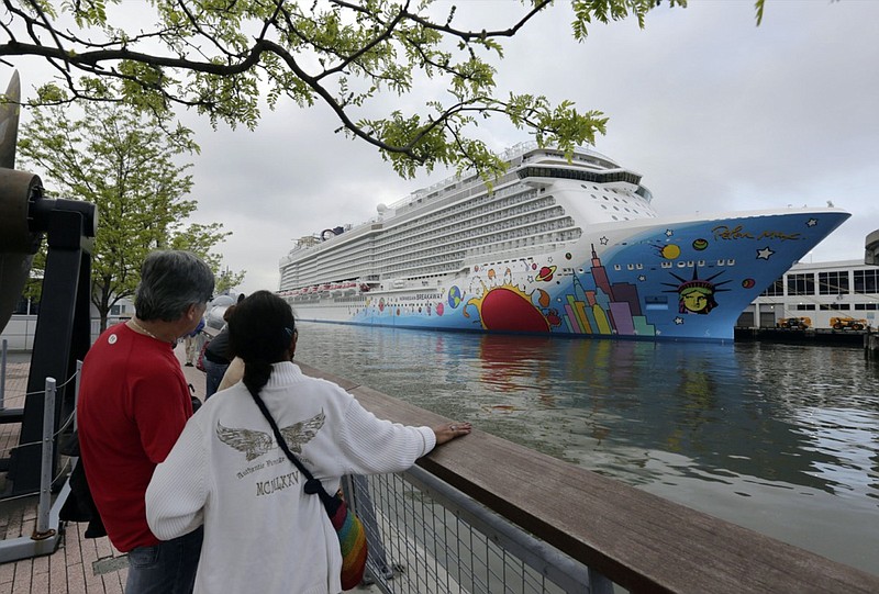 FILE - In this May 8, 2013, file photo, people pause to look at Norwegian Cruise Line's ship, Norwegian Breakaway, on the Hudson River, in New York. On Monday, April 5, 2021, Norwegian Cruise Line's parent company asked the Centers for Disease Control and Prevention for permission to resume cruises from U.S. ports on July 4 by requiring passengers and crew members to be vaccinated against COVID-19 at least two weeks before the trip. (AP Photo/Richard Drew, File)