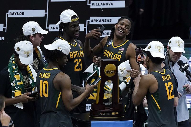 Baylor players celebrate with the trophy at the end of the championship game against Gonzaga in the men's Final Four NCAA college basketball tournament, Monday, April 5, 2021, at Lucas Oil Stadium in Indianapolis. Baylor won 86-70. (AP Photo/Michael Conroy)
