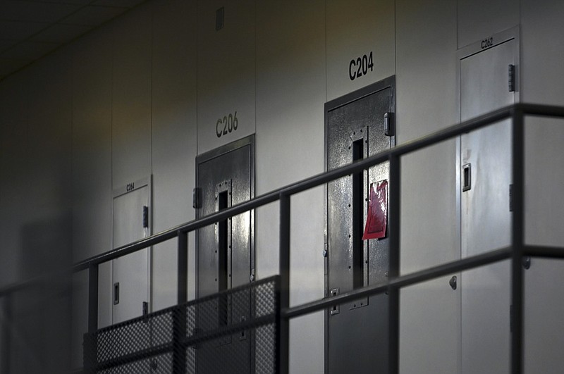 FILE - In this Jan. 4, 2021, file photo, a red tag hangs on a cell door, signifying an active COVID-19 case for its inhabitants at Faribault Prison, in Faribault, Minn. Fewer than 20 percent of state and federal prisoners have received a COVID-19 vaccine, according to data collected by The Marshall Project and The Associated Press. In some states, prisoners and advocates have resorted to lawsuits to get access. (Aaron Lavinsky/Star Tribune via AP, File)