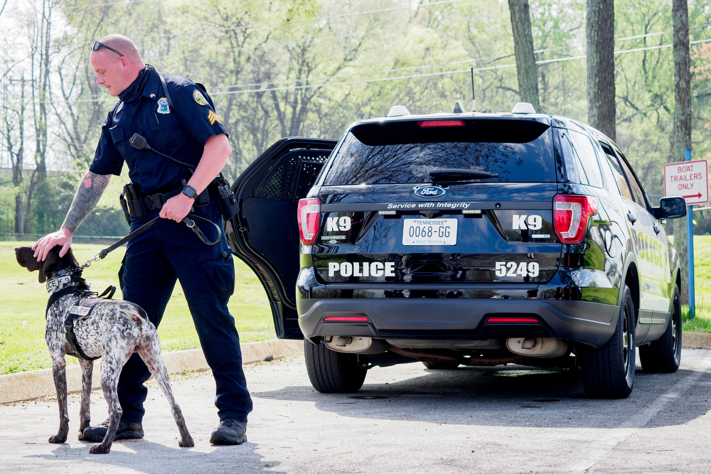 Staff photo by C.B. Schmelter / Chattanooga Police Department Sgt. Sean O'Brien pets K9 Gunther before a press conference at the Tennessee Riverpark on Wednesday, April 7, 2021 in Chattanooga, Tenn.