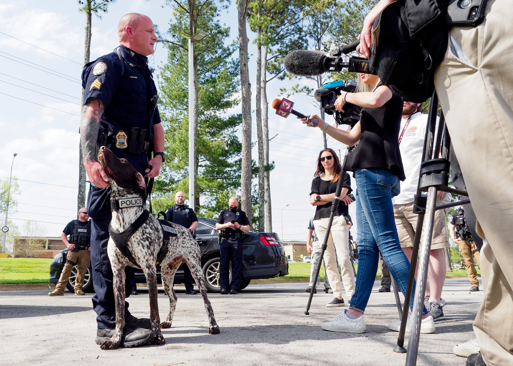Staff photo by C.B. Schmelter / Chattanooga Police Department Sgt. Sean O'Brien stands with K9 Gunther as he speaks during a press conference at the Tennessee Riverpark on Wednesday, April 7, 2021 in Chattanooga, Tenn.