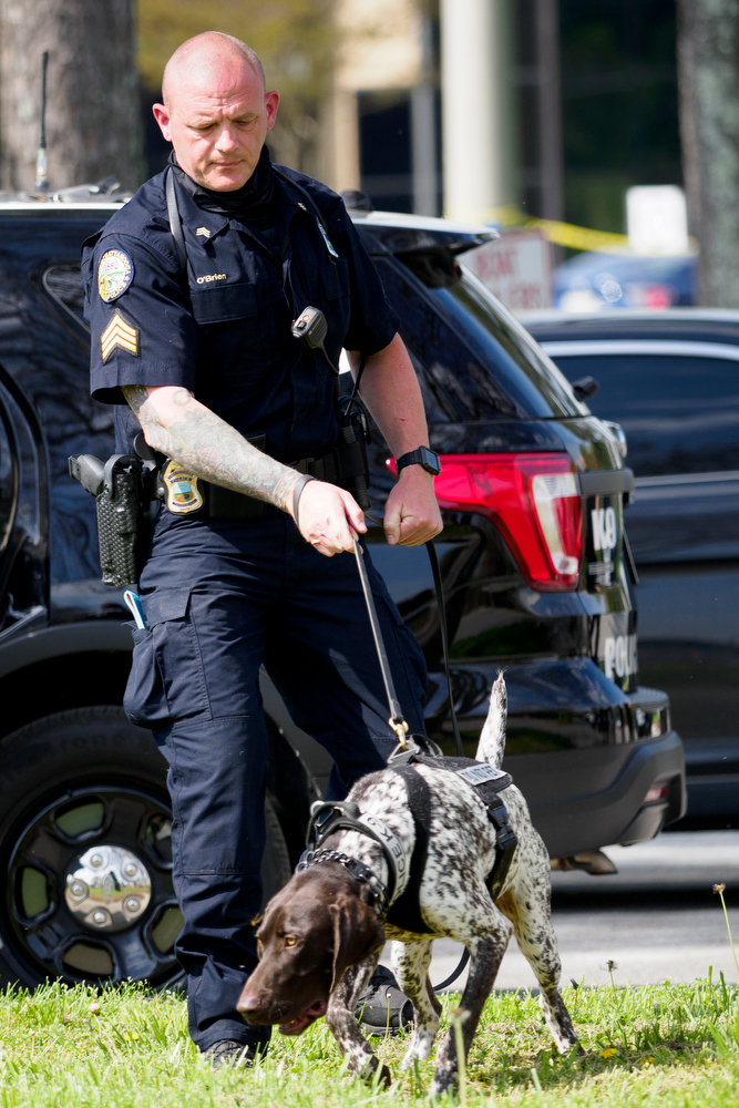 Staff photo by C.B. Schmelter / Chattanooga Police Department Sgt. Sean O'Brien runs a demonstration search for a firearm with K9 Gunther during a press conference at the Tennessee Riverpark on Wednesday, April 7, 2021 in Chattanooga, Tenn.