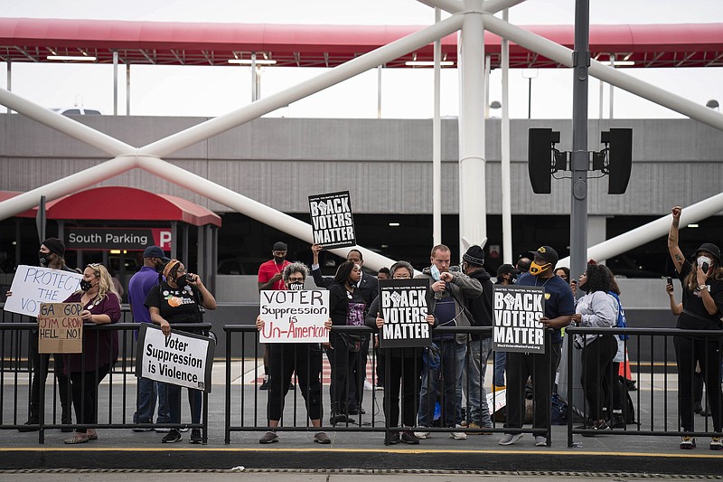Photo by Nicole Craine of The New York Times / Voting-rights activists call for a boycott of Delta Air Lines during a protest at Hartsfield-Jackson Atlanta International Airport in Atlanta on March 25, 2021.