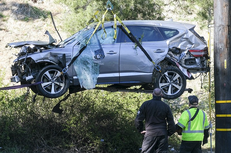 FILE - In this Feb. 23, 2021, file photo, a crane is used to lift a vehicle following a rollover accident involving golfer Tiger Woods, in the Rancho Palos Verdes suburb of Los Angeles. (AP Photo/Ringo H.W. Chiu, File)


